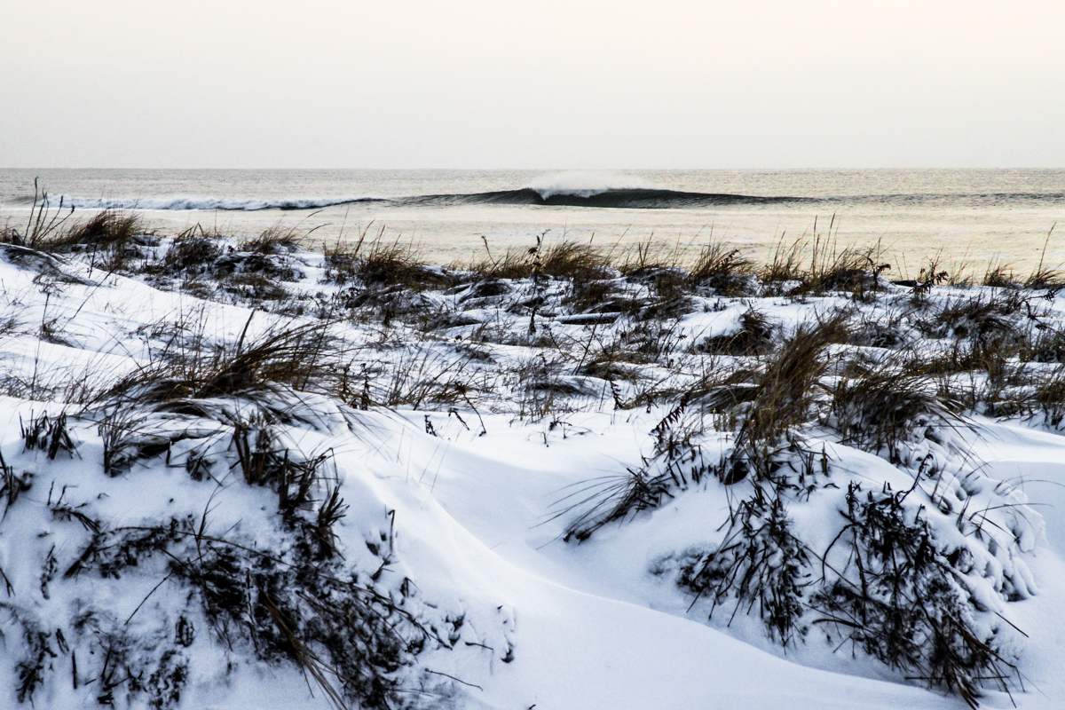 There is nothing better then the solitude of a winter swell, snowy dunes and northwest wind. Photo: Nate Best.