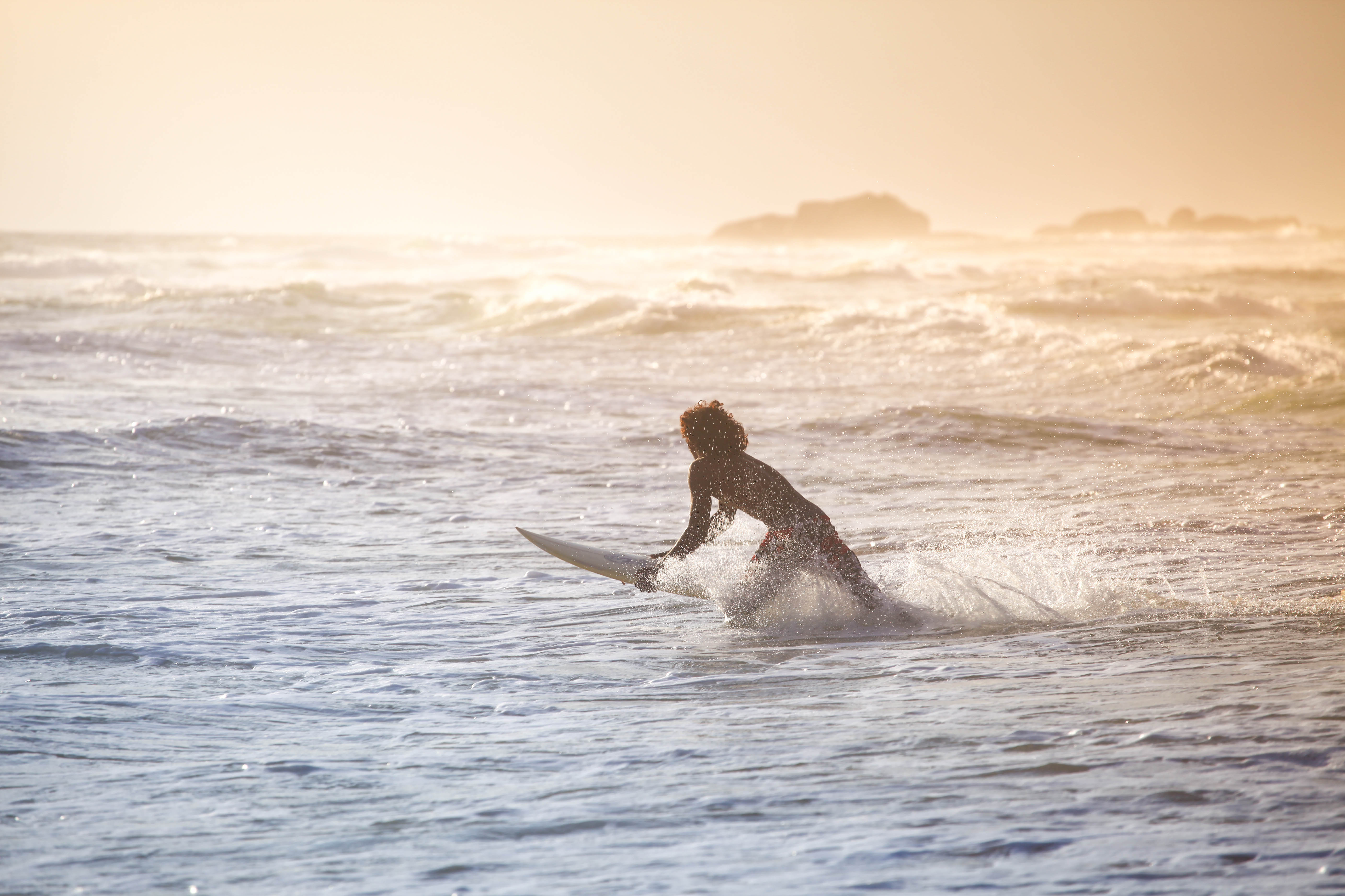 Surfer charging a sunset swell. Photo: Charlie Malmqvist.