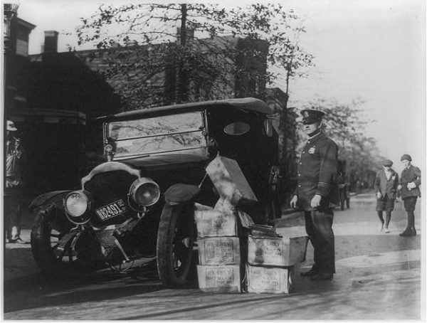 Policeman_and_wrecked_car_and_cases_of_moonshine