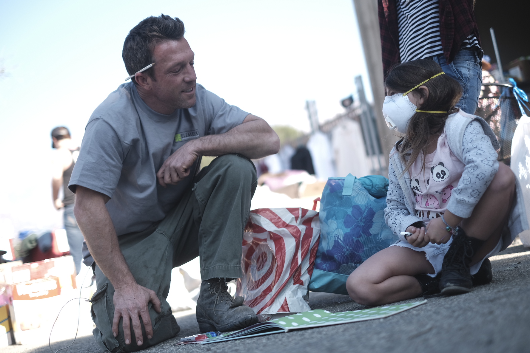 The Thomas Fire ripped through so many homes in December 2017. In response, “Help California” organized a toy drive. Here, a volunteer talks to a little girl who lost everything. 
Photo: Dylan Gordon
