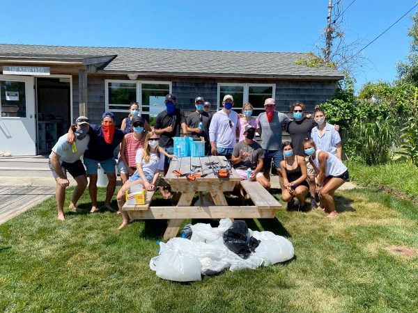 Group of people at a beach cleanup at the Boneyard by Whalebone in Montauk