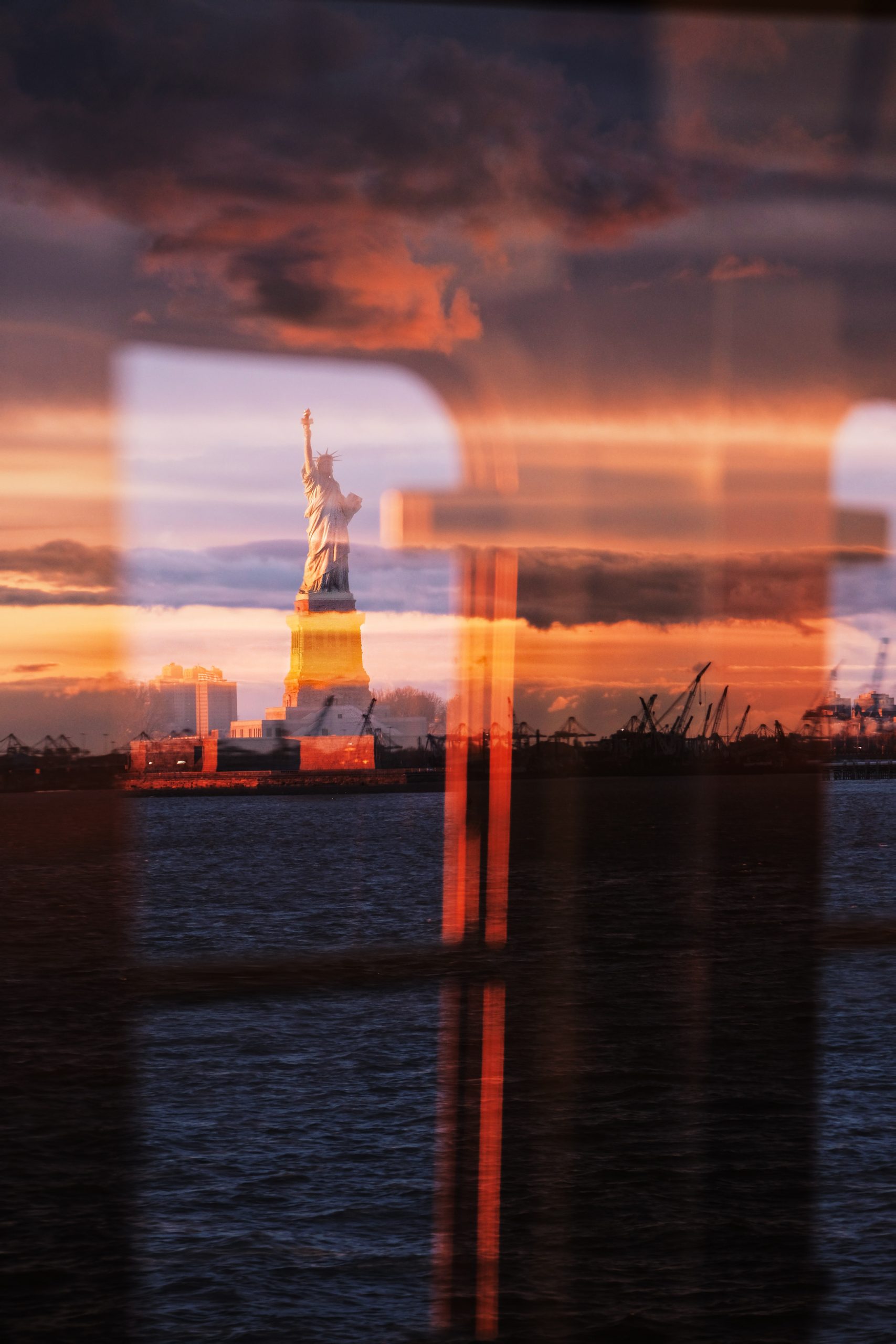 Photograph of New York City and Lady Liberty at sunset by Mike DePetris