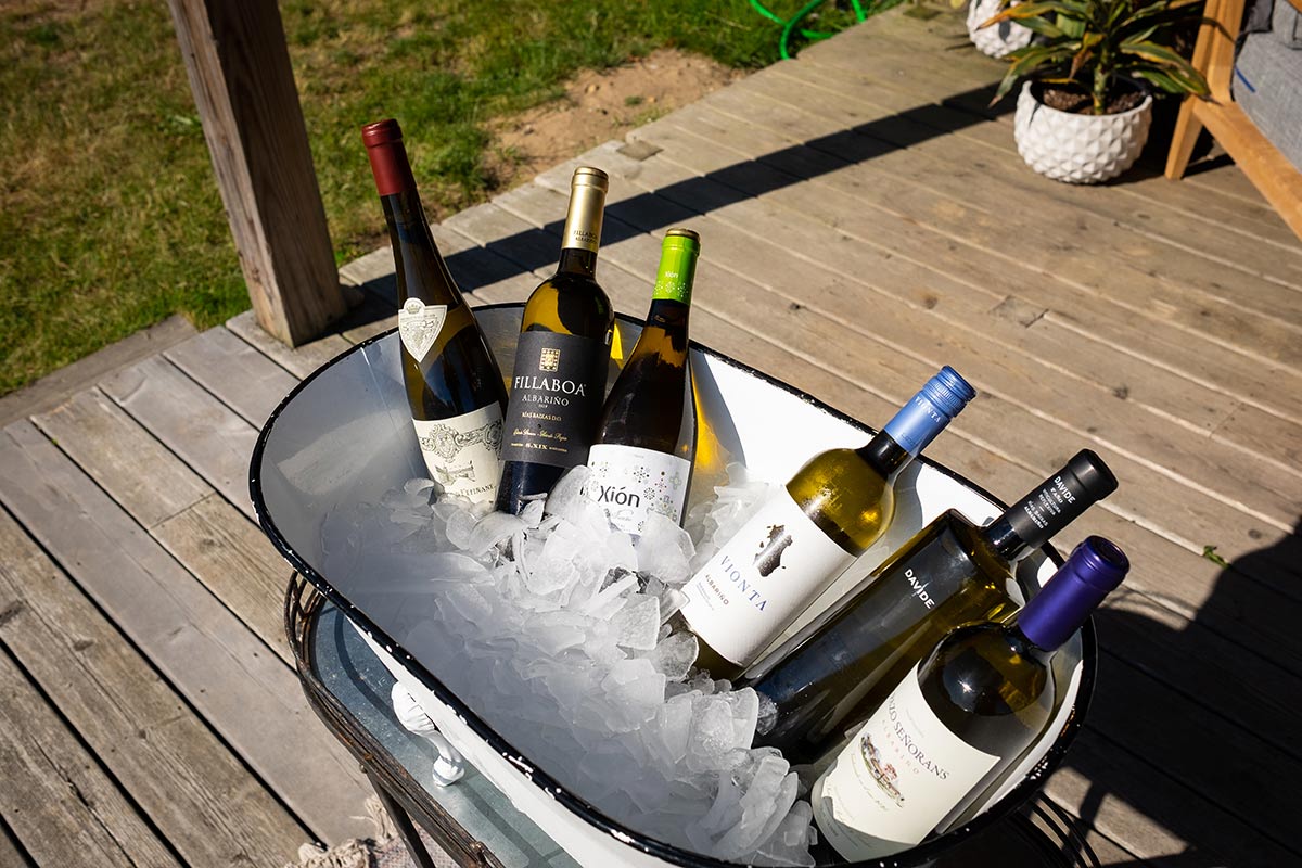 Bucket of ice and bottles of wine sitting on the back wooden deck of the Boneyard.