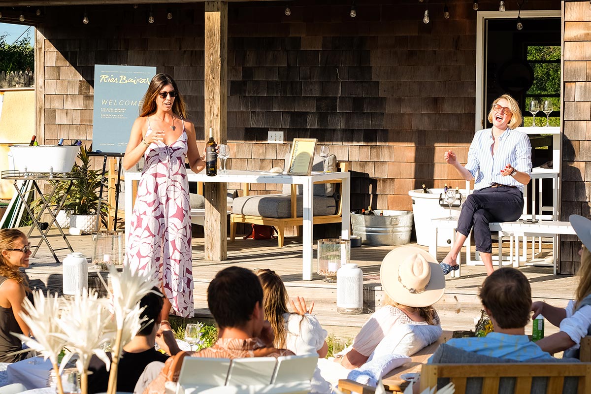 Vanessa Price and attendees sit outside in the sun in the backyard of the Boneyard by Whalebone in Montauk.