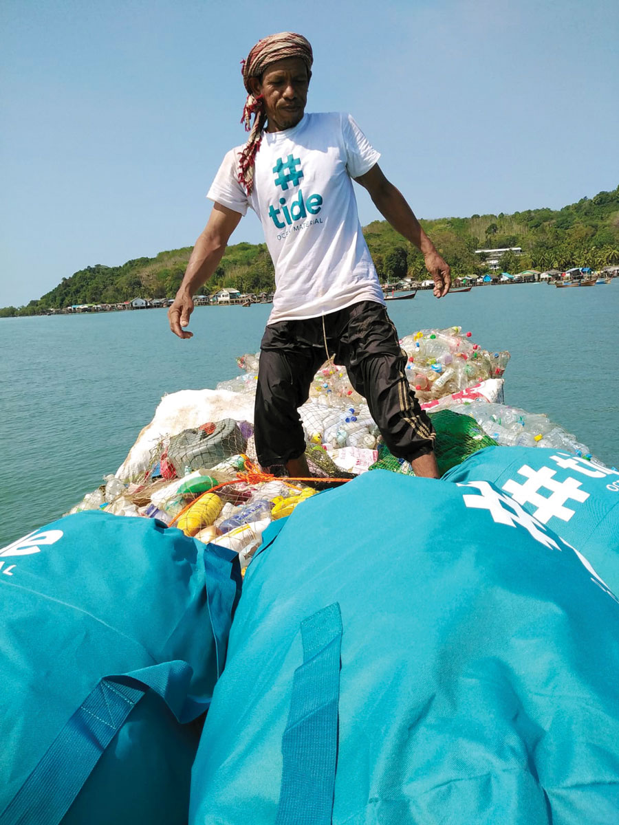 Man on boat with bags of trash