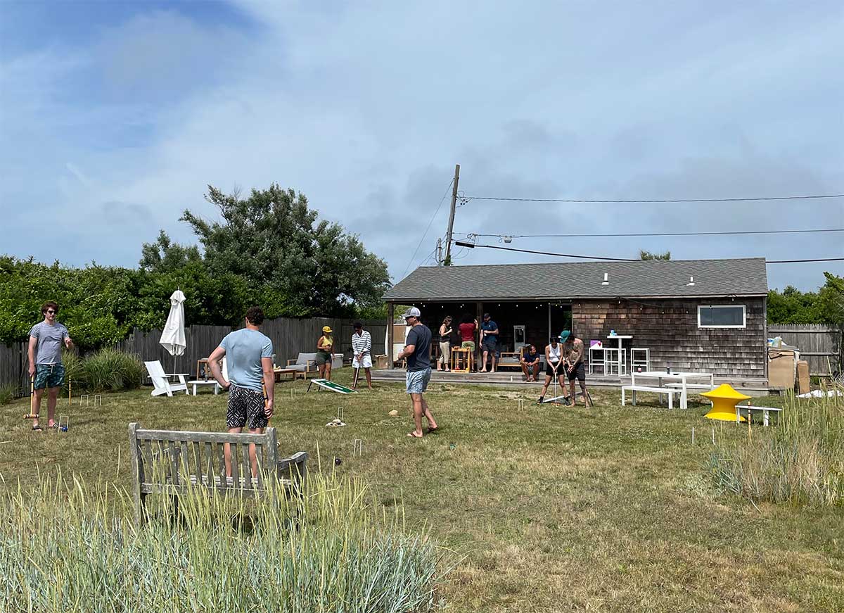 People play a game of croquet in the backyard of the boneyard during the Fair Harbor Gin Beach Cleanup and Happy Hour in Montauk