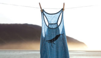 humpback whale tank top hung up on a line at the beach