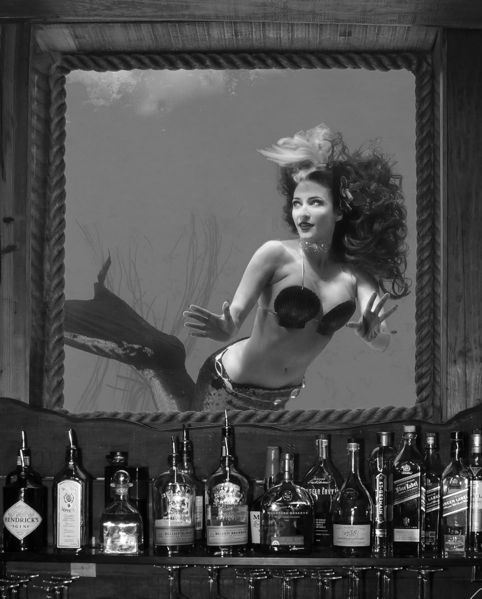 Black and white photograph of Marina Anderson. She's dressed as a mermaid while underwater.
