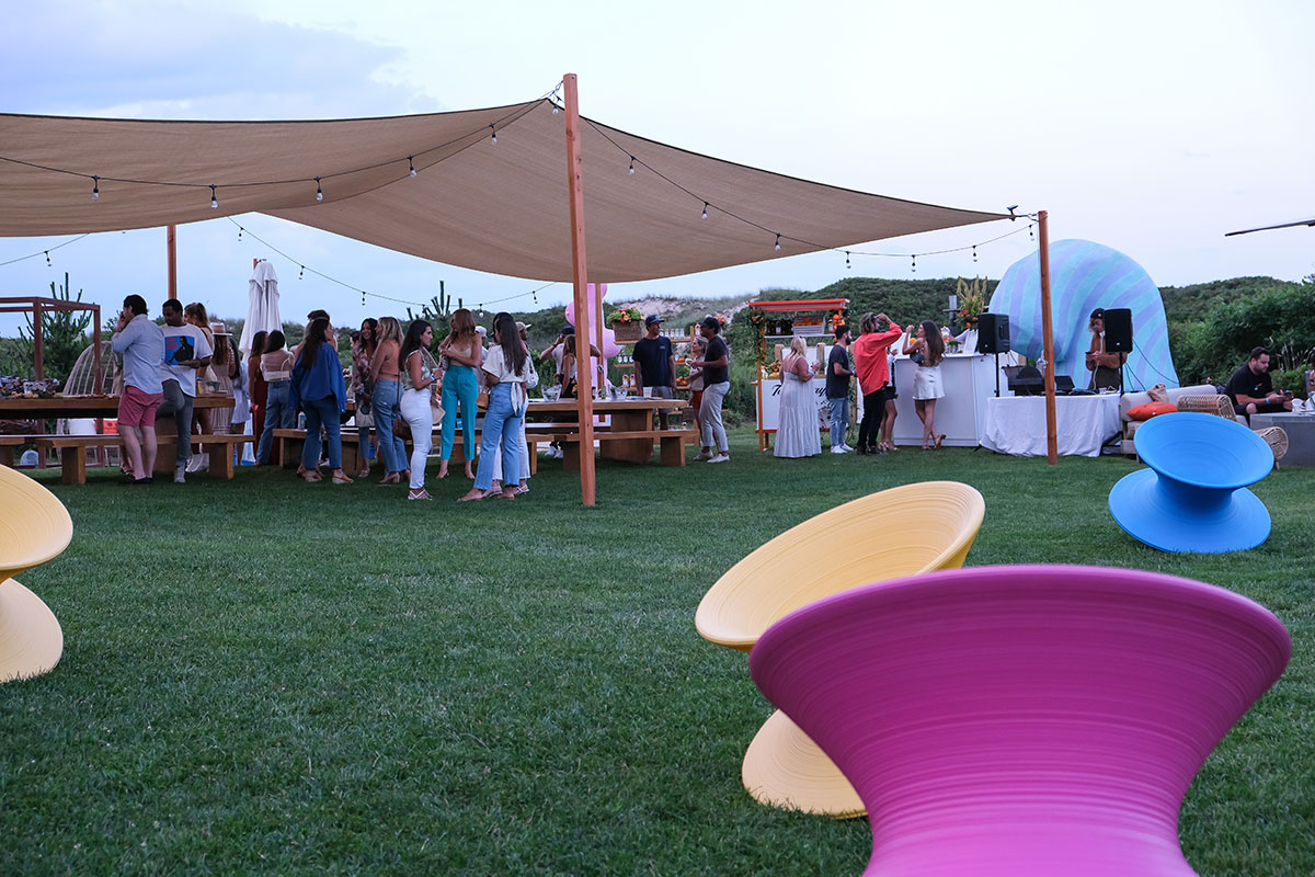 A large tent covers the party guests while standing outside at the Tanqueray event at Hero Beach Club in Montauk 