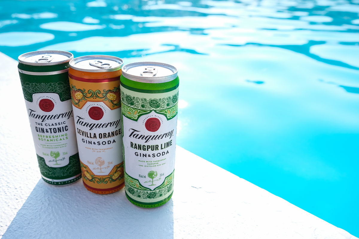 Tanqueray canned cocktails next to the pool 
