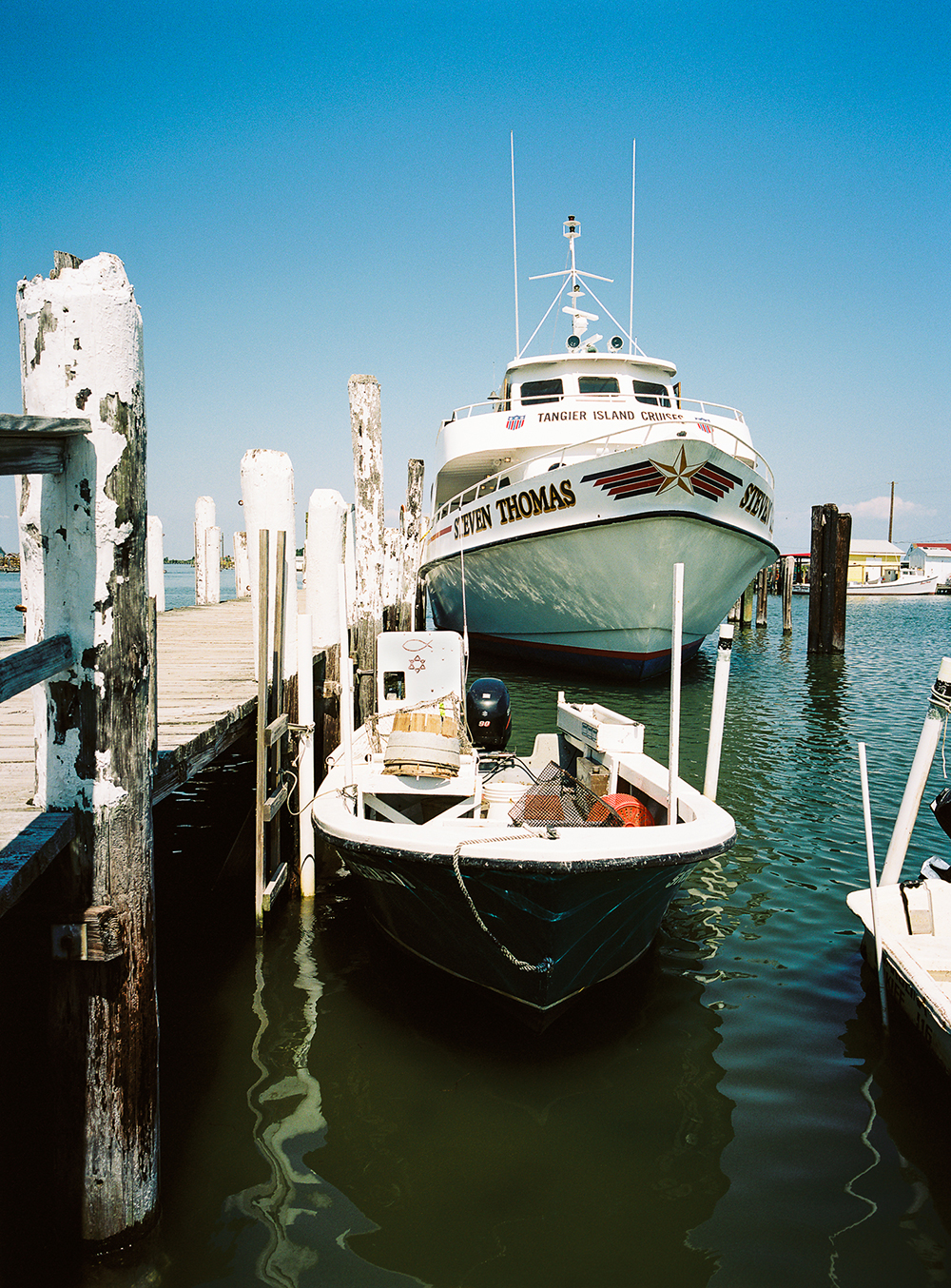 Photograph by Gunner Hughes of dock and boats on Tangier Island, Chesapeake Bay
