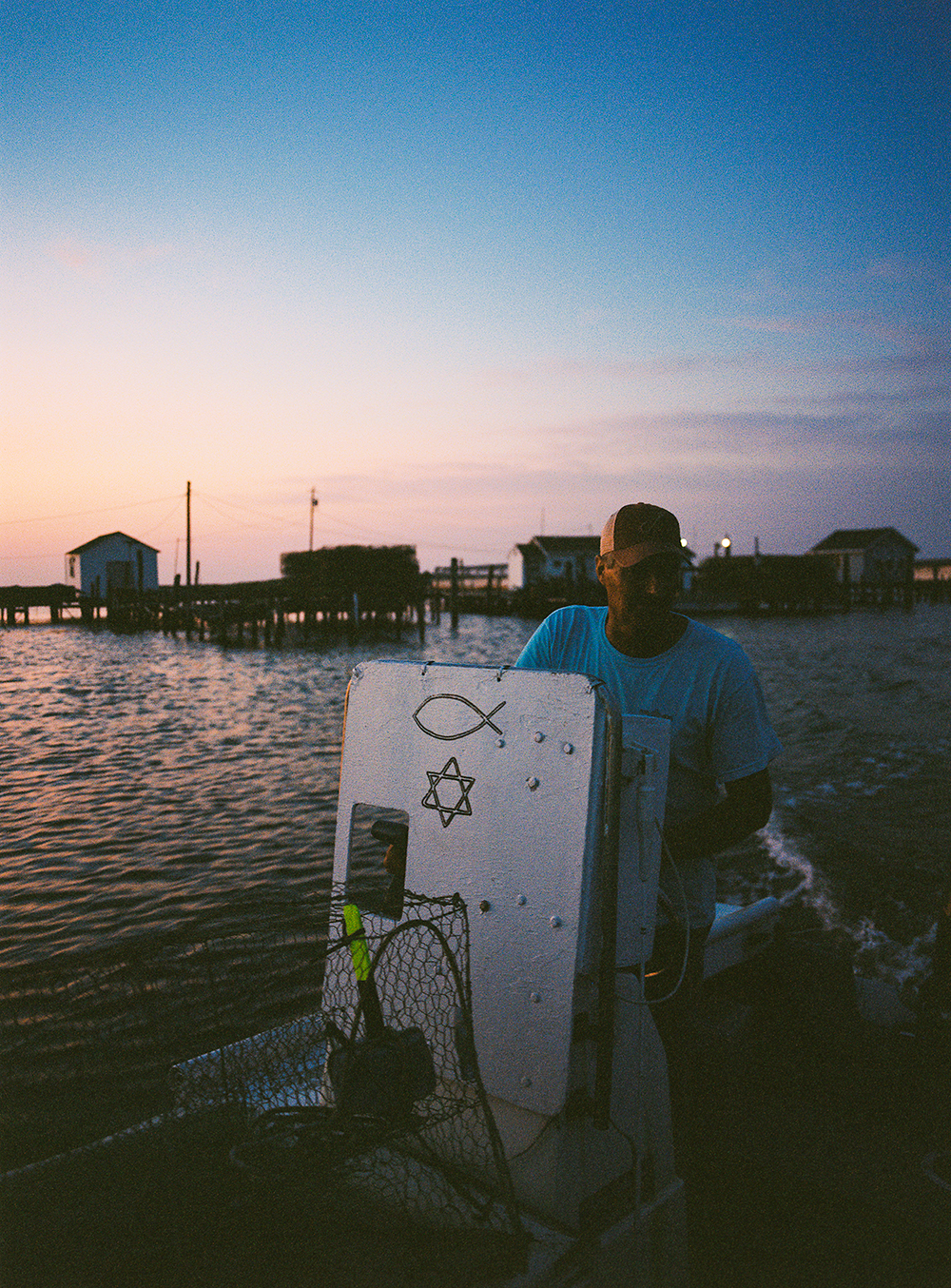 Photograph by Gunner Hughes of boater at sunset on Tangier Island, Chesapeake Bay