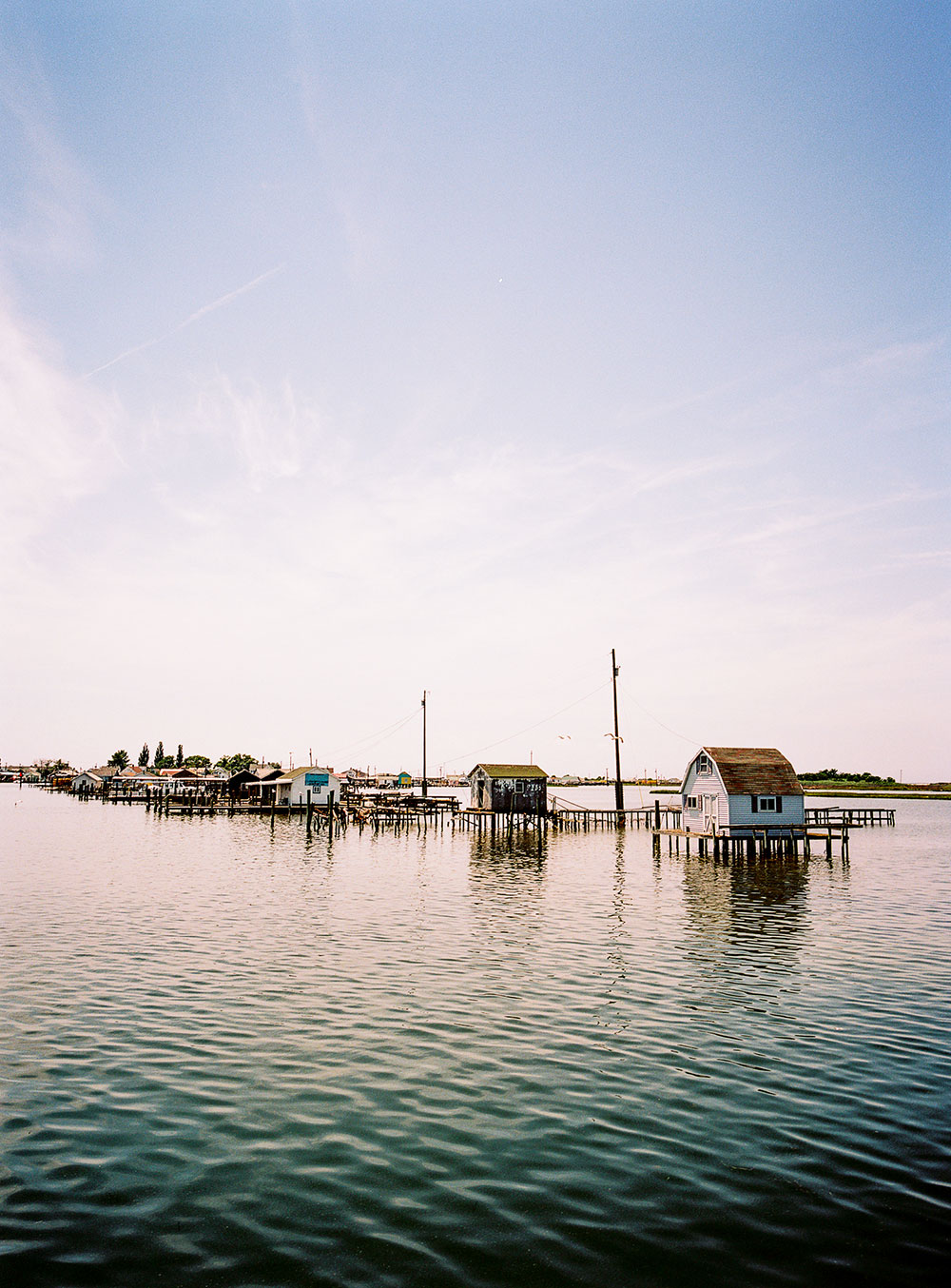 Photograph by Gunner Hughes of houses on stilts at Tangier Island, Chesapeake Bay