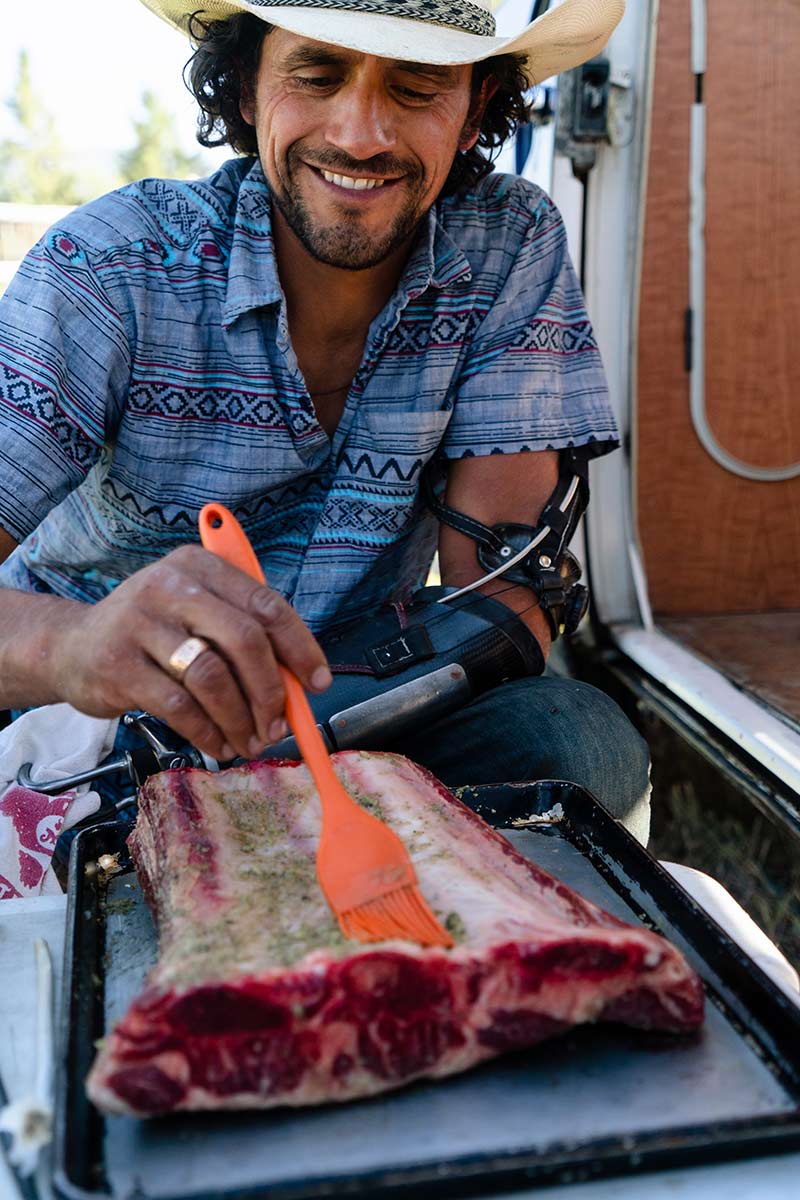 Chef Eduardo Garcia prepares a slab of meat