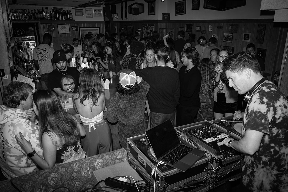 DJ William Grand performing at Whalebone Magazine Hippie Issue Release Party with crowd dancing at the Flower Shop in New York City 