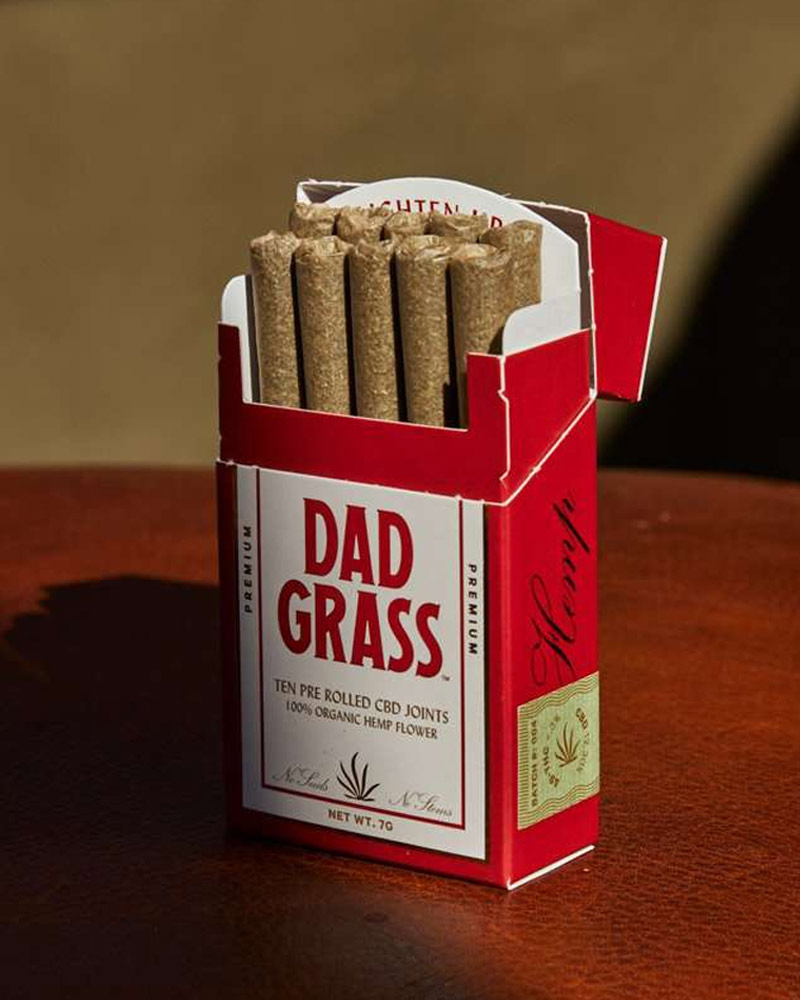 A close up photograph of the red and white paper carton with joints of Dad Grass