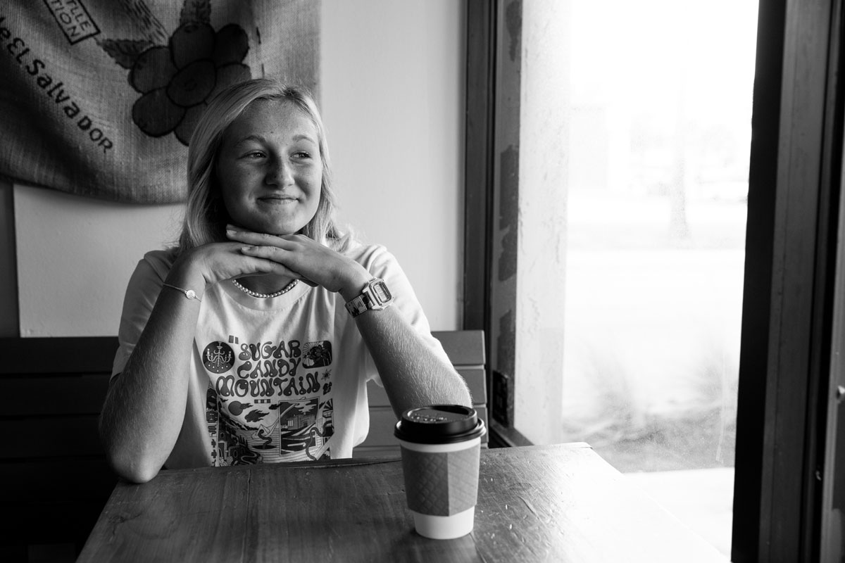 Black and white photo Kylie Pulcini having coffee and smiling