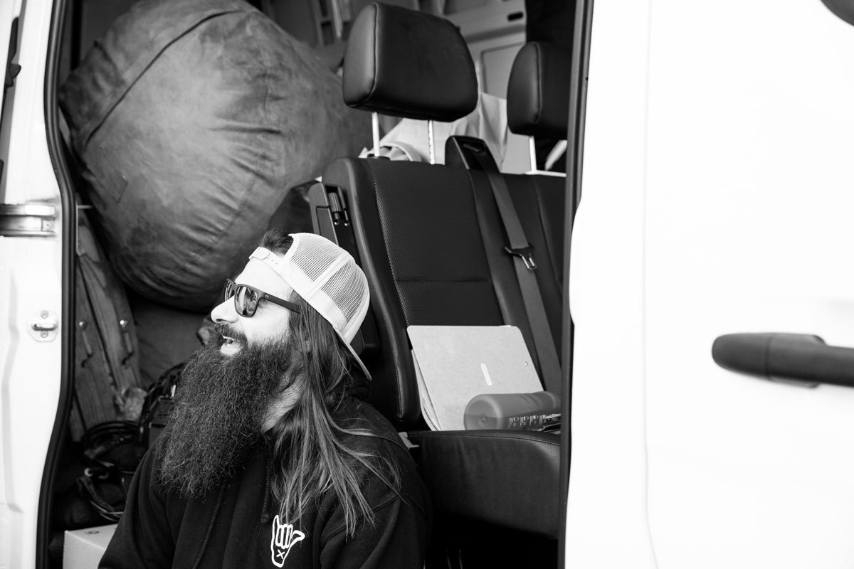 Black and white photo of Dustin sittin in van.