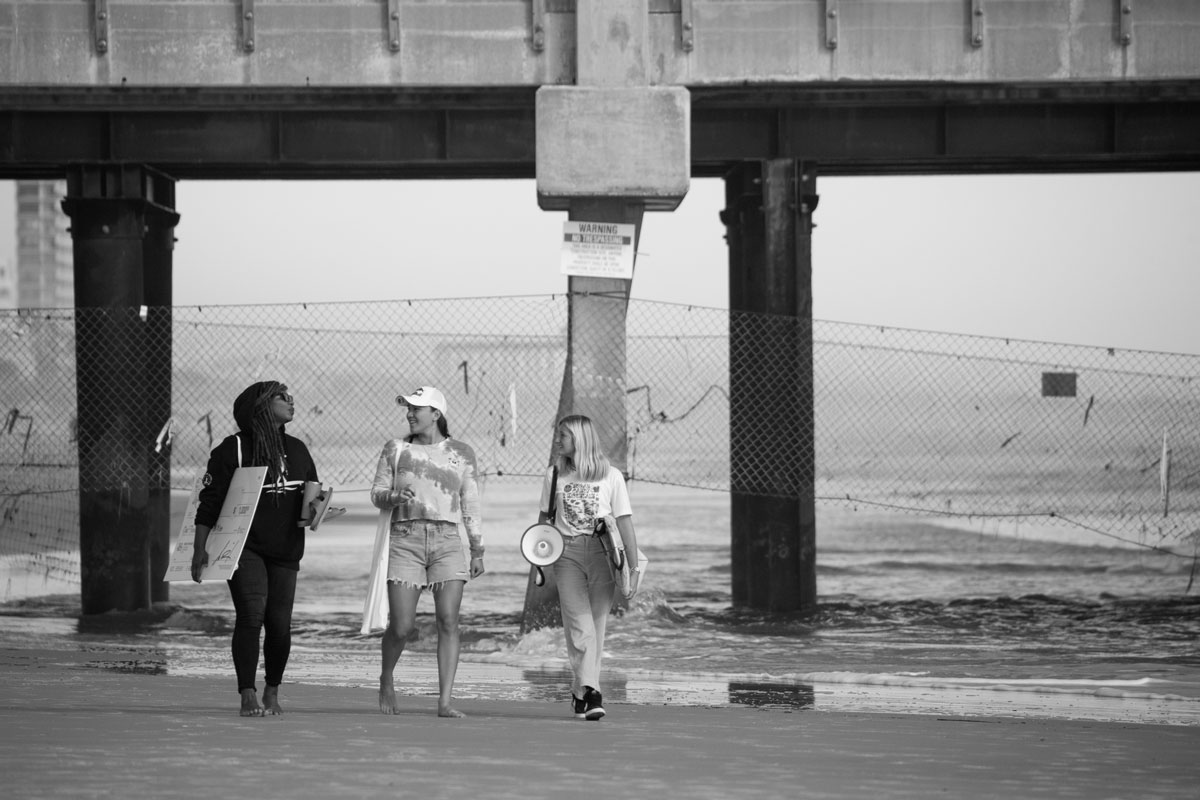 Black and white photo judges walking under the pier.