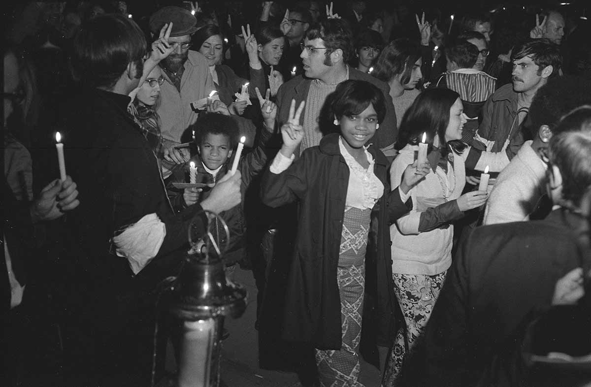 Crowd of people holding candles at a march at night to the White House, led by Coretta Scott King as part of the Moratorium to End the War in Vietnam which took place in Washington DC | October 1969 | Retrieved from the Library of Congress