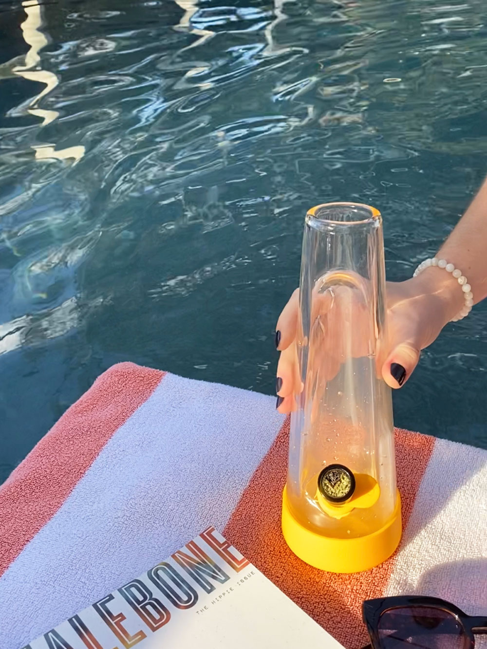 grabbing session goods bong for friends by edge of pool