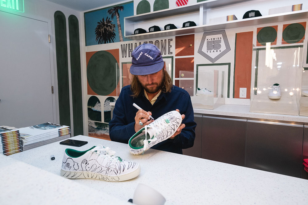 Artist Ty Williams drawing on K-Swiss tennis shoes at Whalebone x K-Swiss Art Basel pop-up at SHOWFIELDS Miami