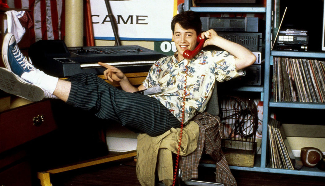 Ferris Bueller in room holding a phone up to his ear.