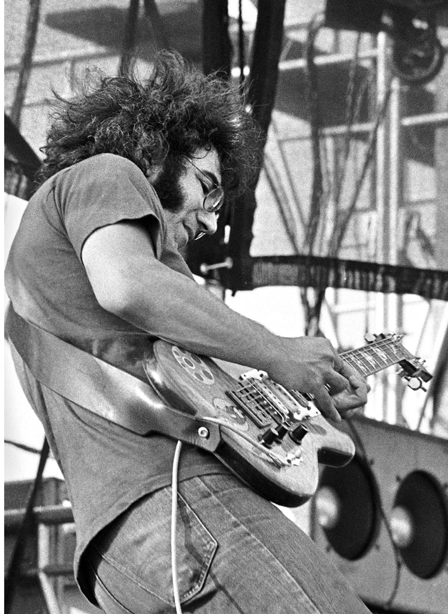 Jerry Garcia playing guitar on stage