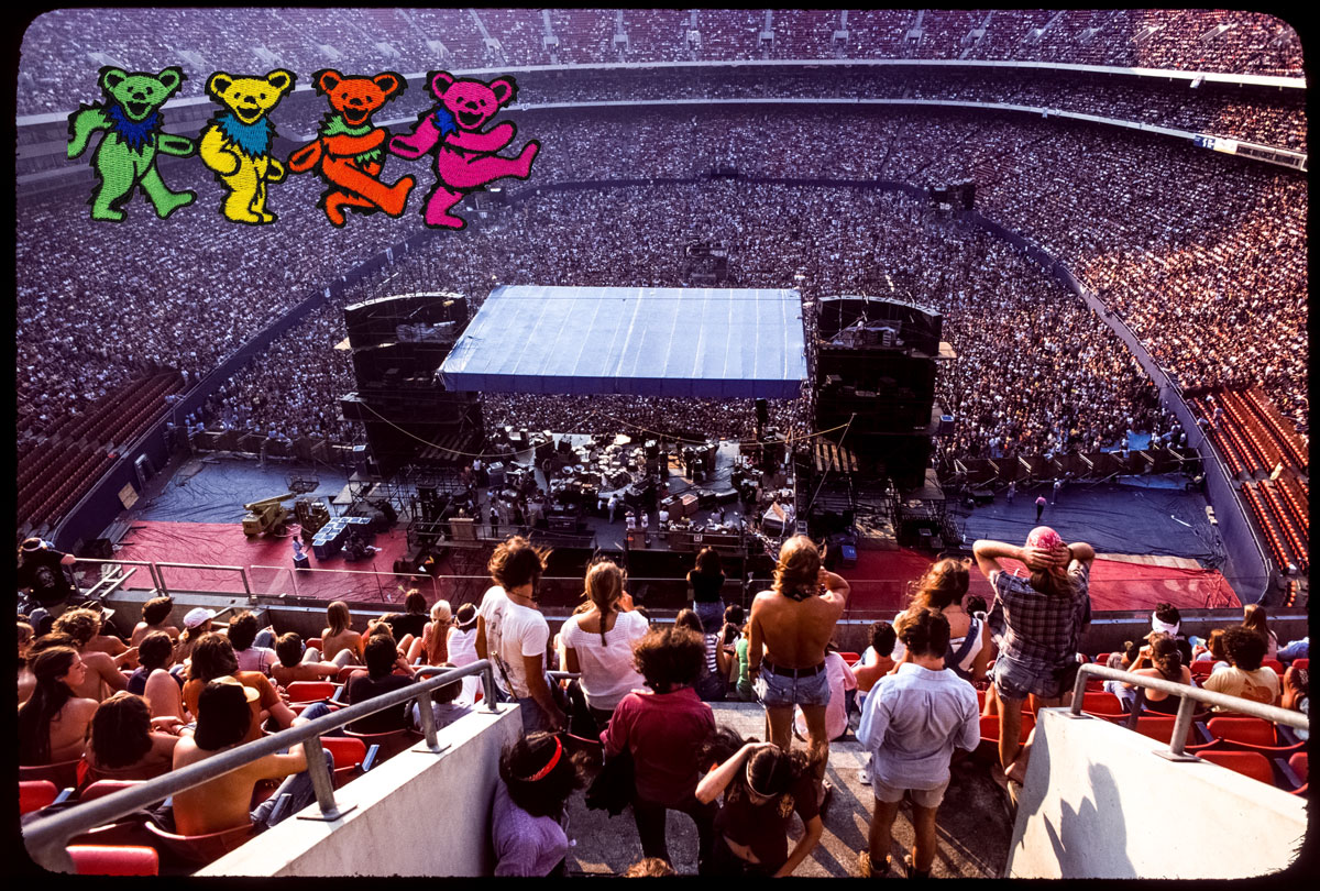 Giants stadium, looking down onto the stage with huge crowd and grateful dead bears badge on the corner.
