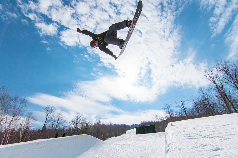 Snowboarder during large jump at Loon Terrain Park at Loon Mountain, NH