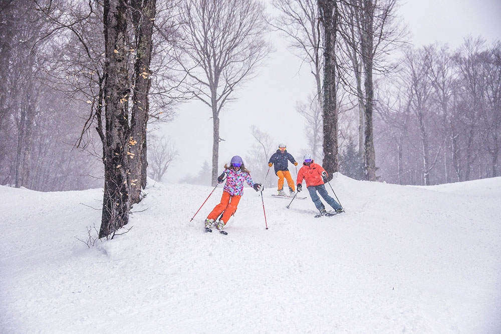 Three Skiers in the snow at Sugarbush Mountain, VT