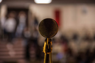 Point of view photo of standing behind a microphone on stage