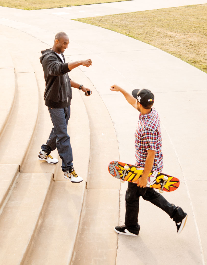 Atiba Jefferson photo's of Kobe Bryant as he walks down steps and fist bumps another man walking up the stairs and holding a skate board.