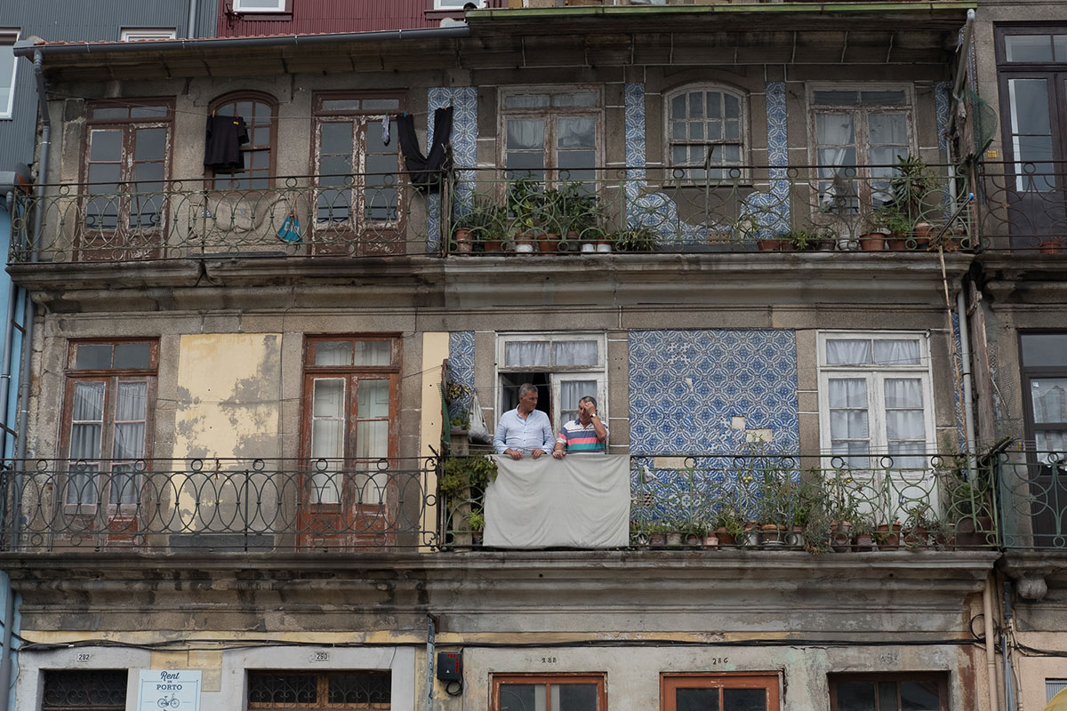 Photo taken by Gunner Hughes of two men on balcony somewhere in Europe