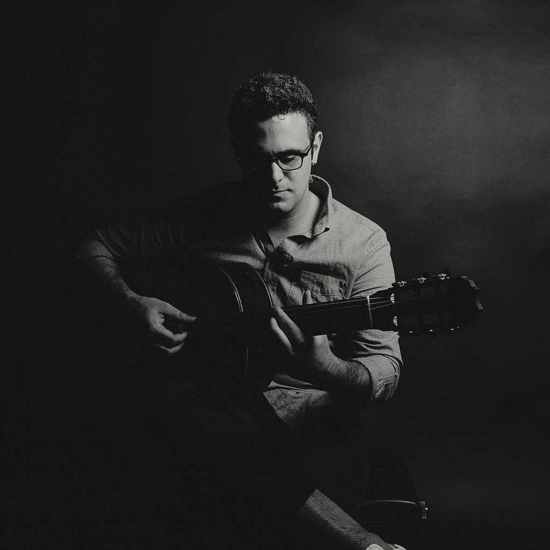 Image of Photographer Neil Schwartz holding a guitar
