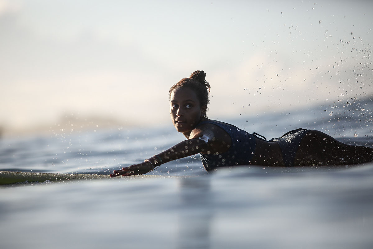 Nature of Surf Women, woman paddling on surf board