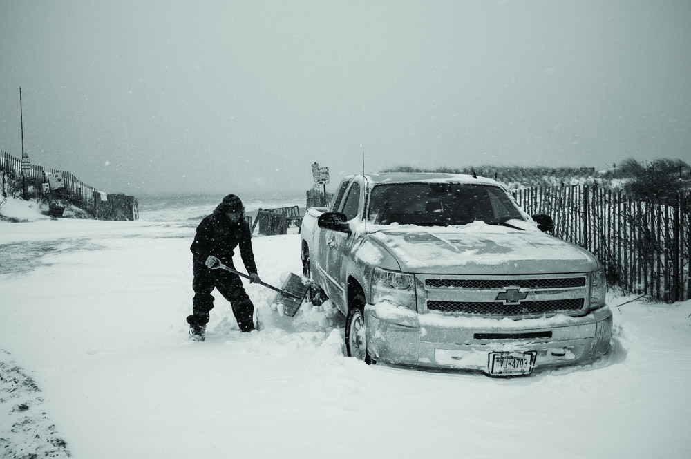 Nickboy digging out a truck stuck in snow on the beach in Montauk