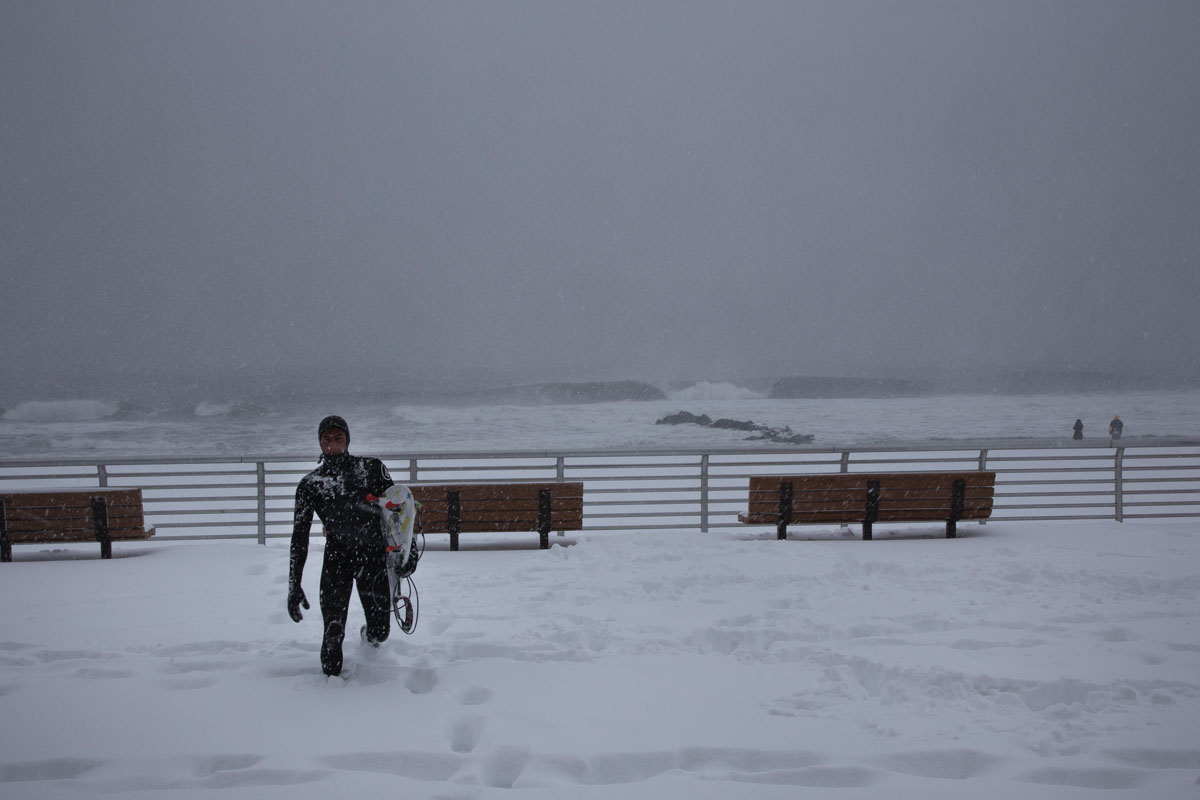 Balaram Stack trudging in the snow toward the ocean