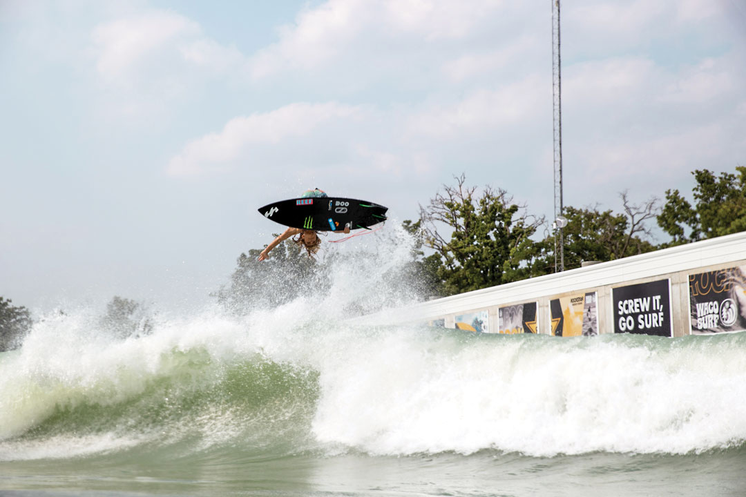 15-year-old surfer, Jackson Dorian flipping mid-air with his board at a  wave pool in Waco, Texas.
