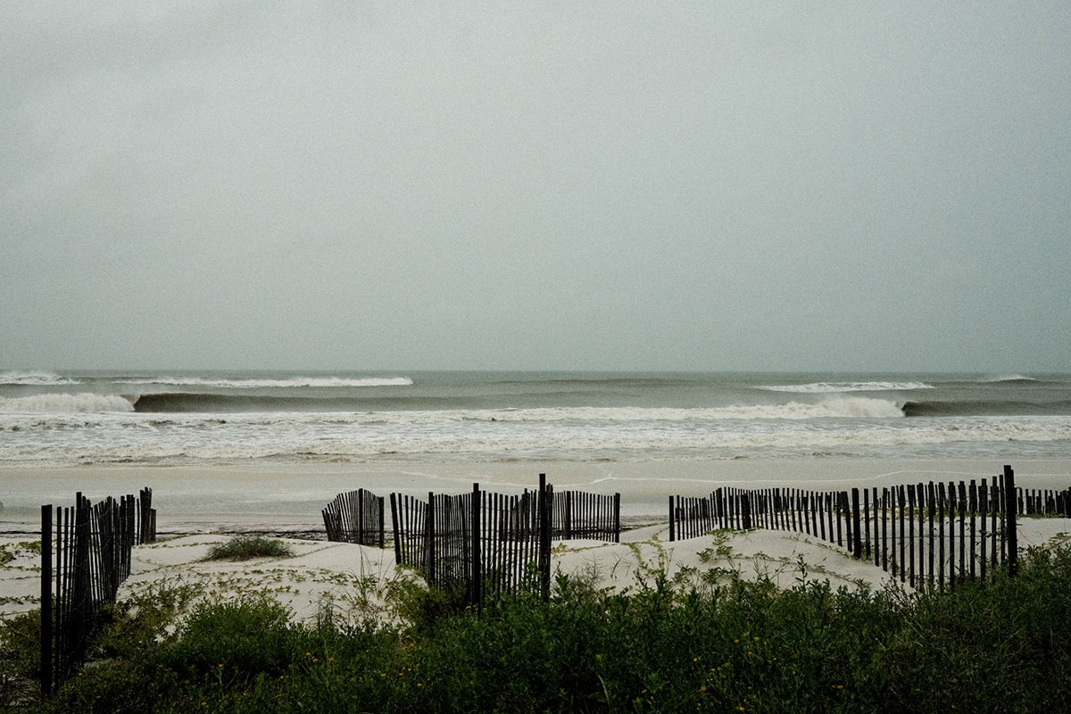 stormy ocean with dune fence