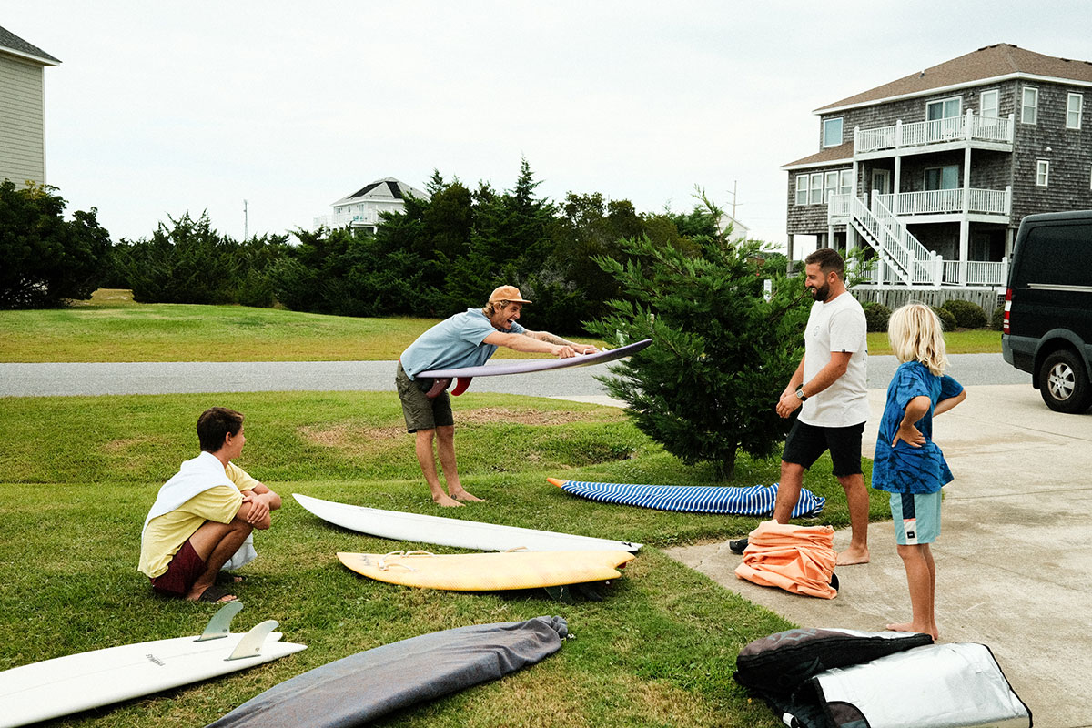 surfers on grass with multiple boards
