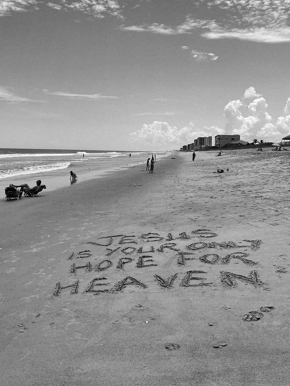 jesus is your hope for heaven written in sand on the beach