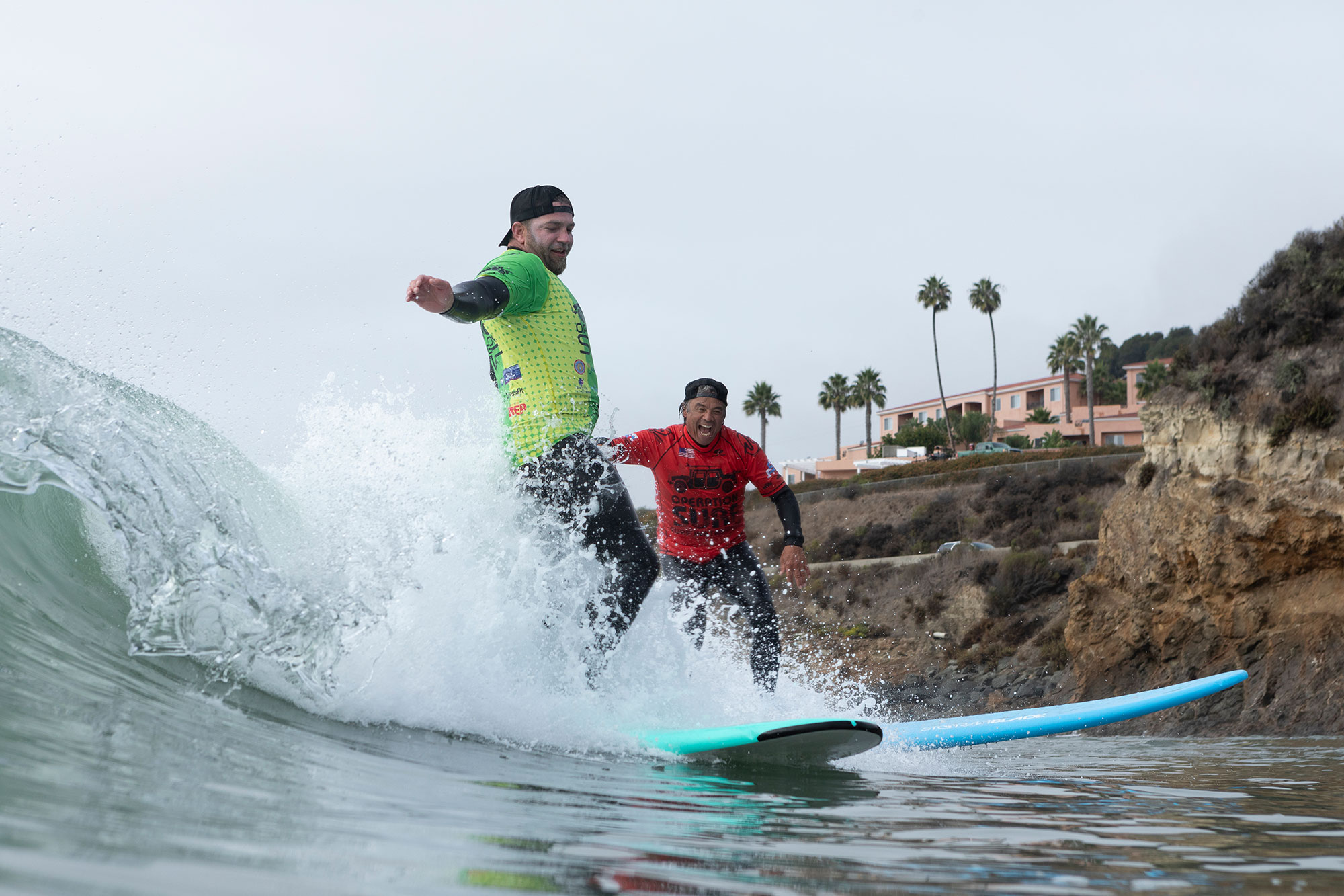 Neil, veteran and Van, founder of operation surf, surfing wave together