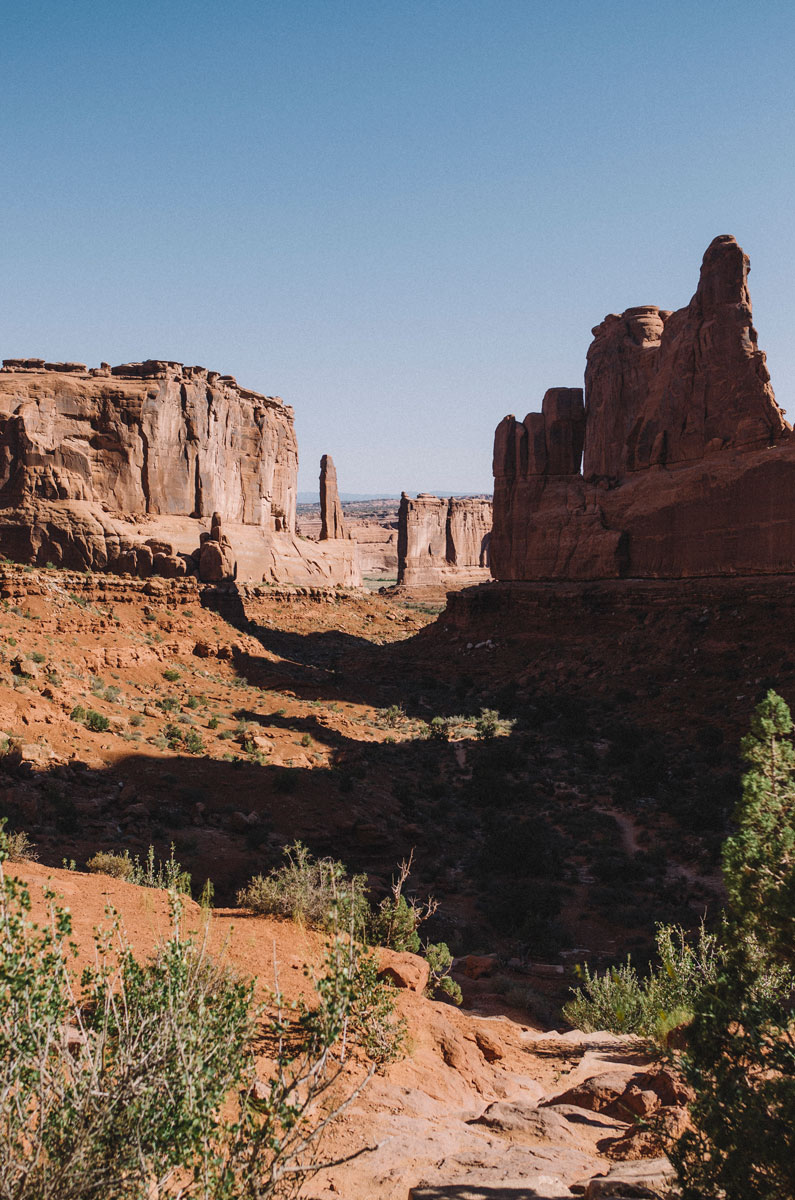 Arches National Park landscape with big rock pillars in the distance.