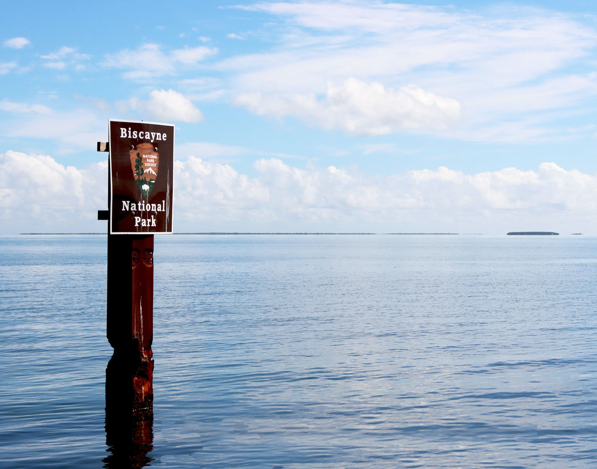 Biscayne National Park sign on post in water