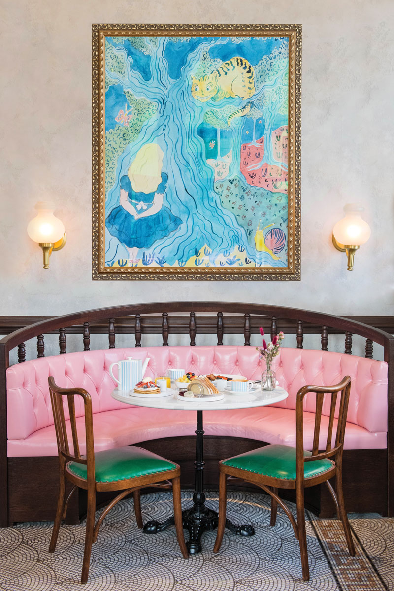 The Alice pink bench with framed blue art print on the wall with breakfast on the table