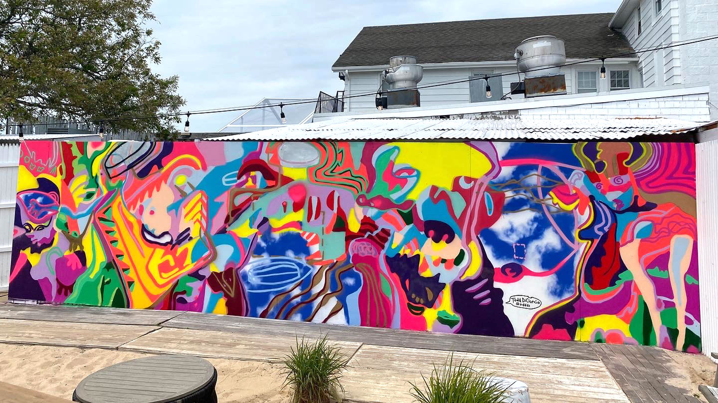 The completed mural by Todd DiCiurcio on the side wall at The Surf Lodge in Montauk, NY.