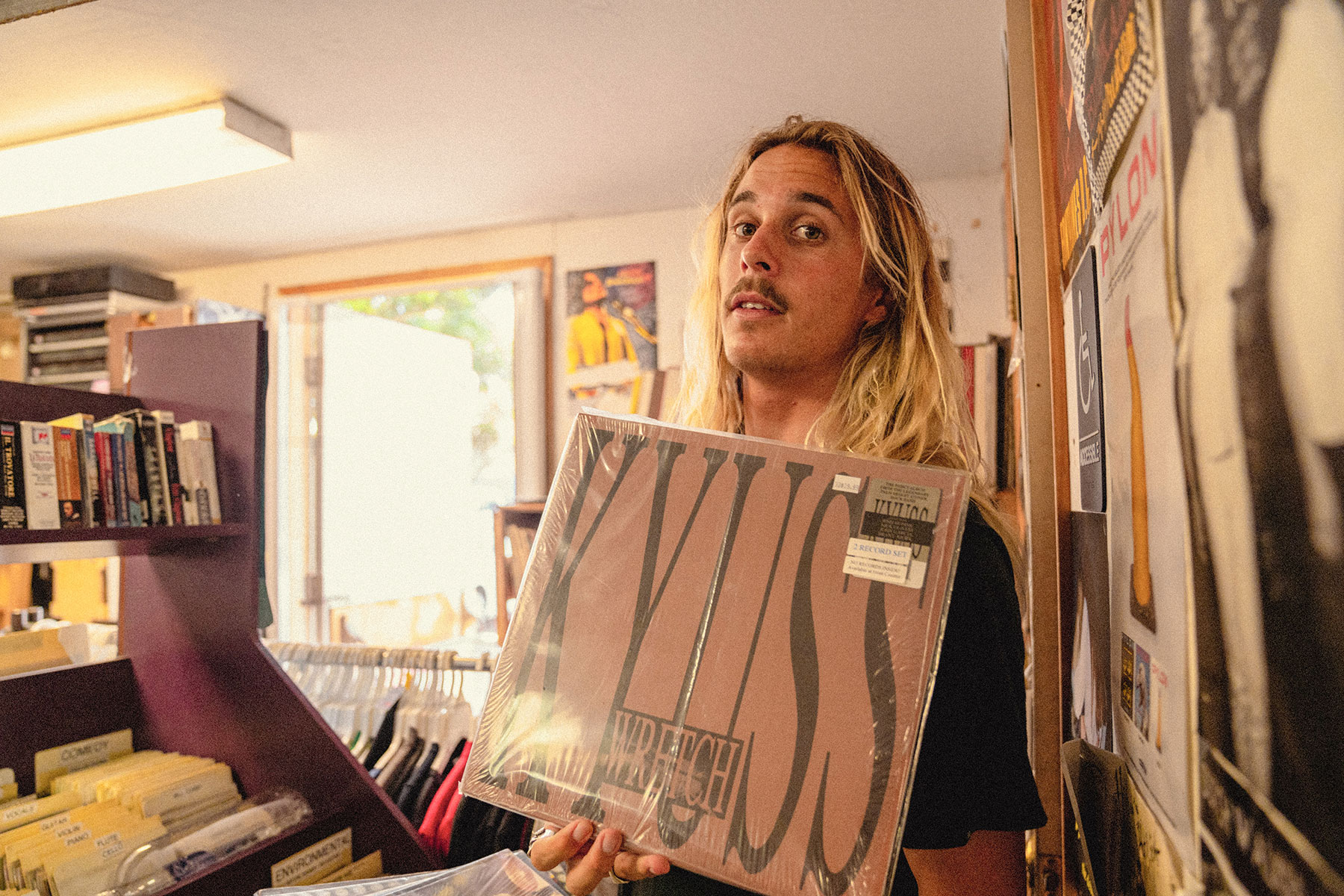 professional surfer Kyuss King holding up Kyuss record