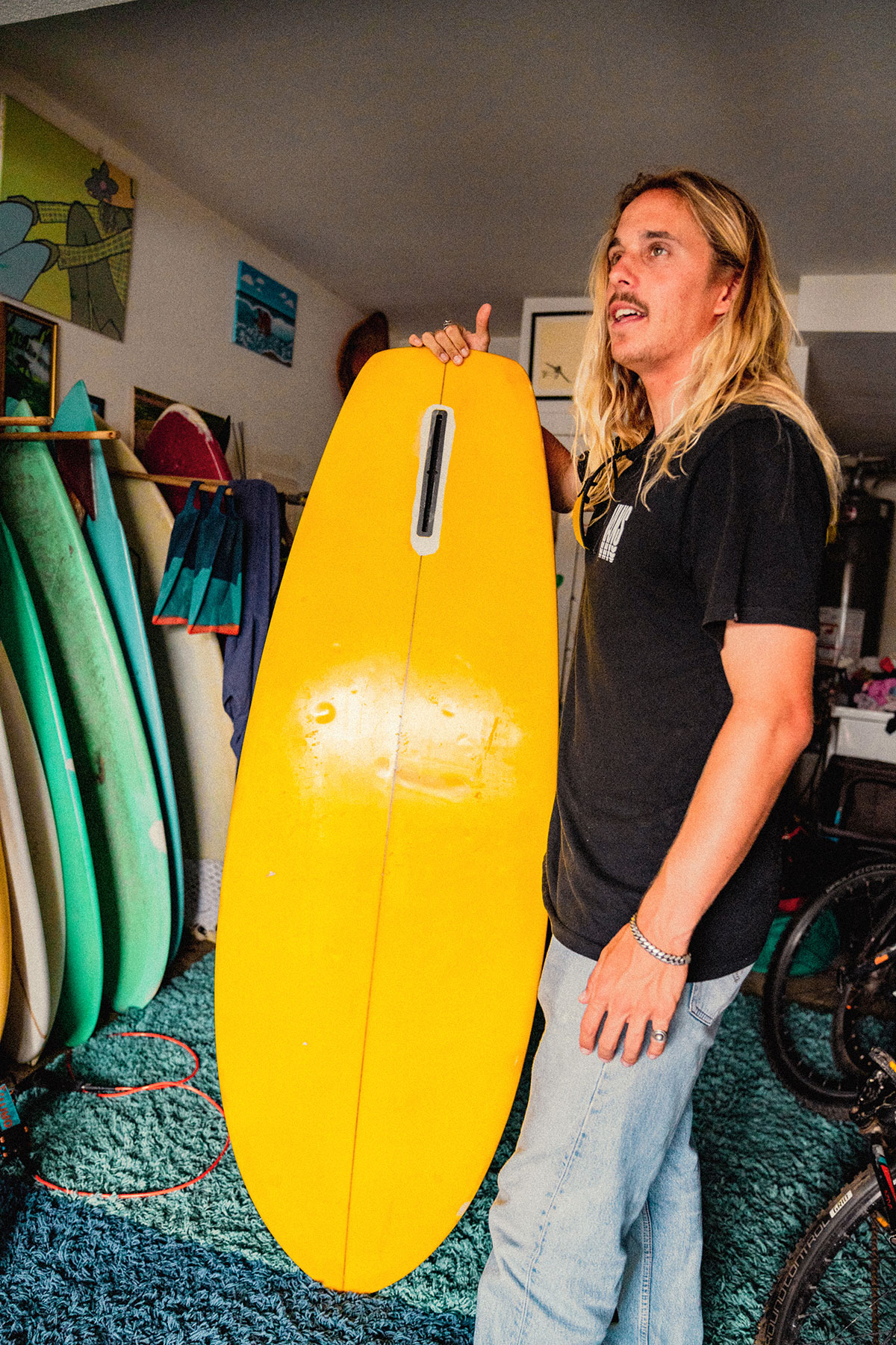 professional surfer Kyuss King holding surf board