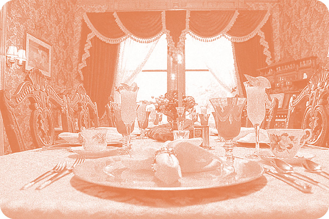 A table setting in a fancy dinning room. The chairs pushed into the table have ornate carvings at the top, fancy drink glasses cover the table, and formal place settings are in front of each chair. The walls are covered in decorative wallpaper and decorative curtains adorn the windows in the back. The photo has been edited to have a white and pink color overlay.